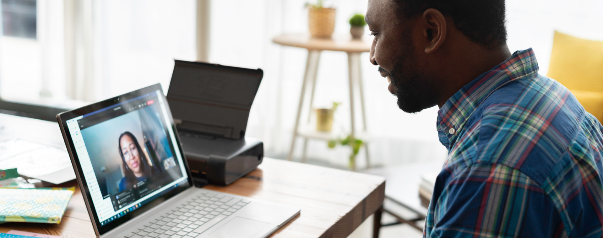 Man attending a telehealth consultation with a psychiatrist on a laptop