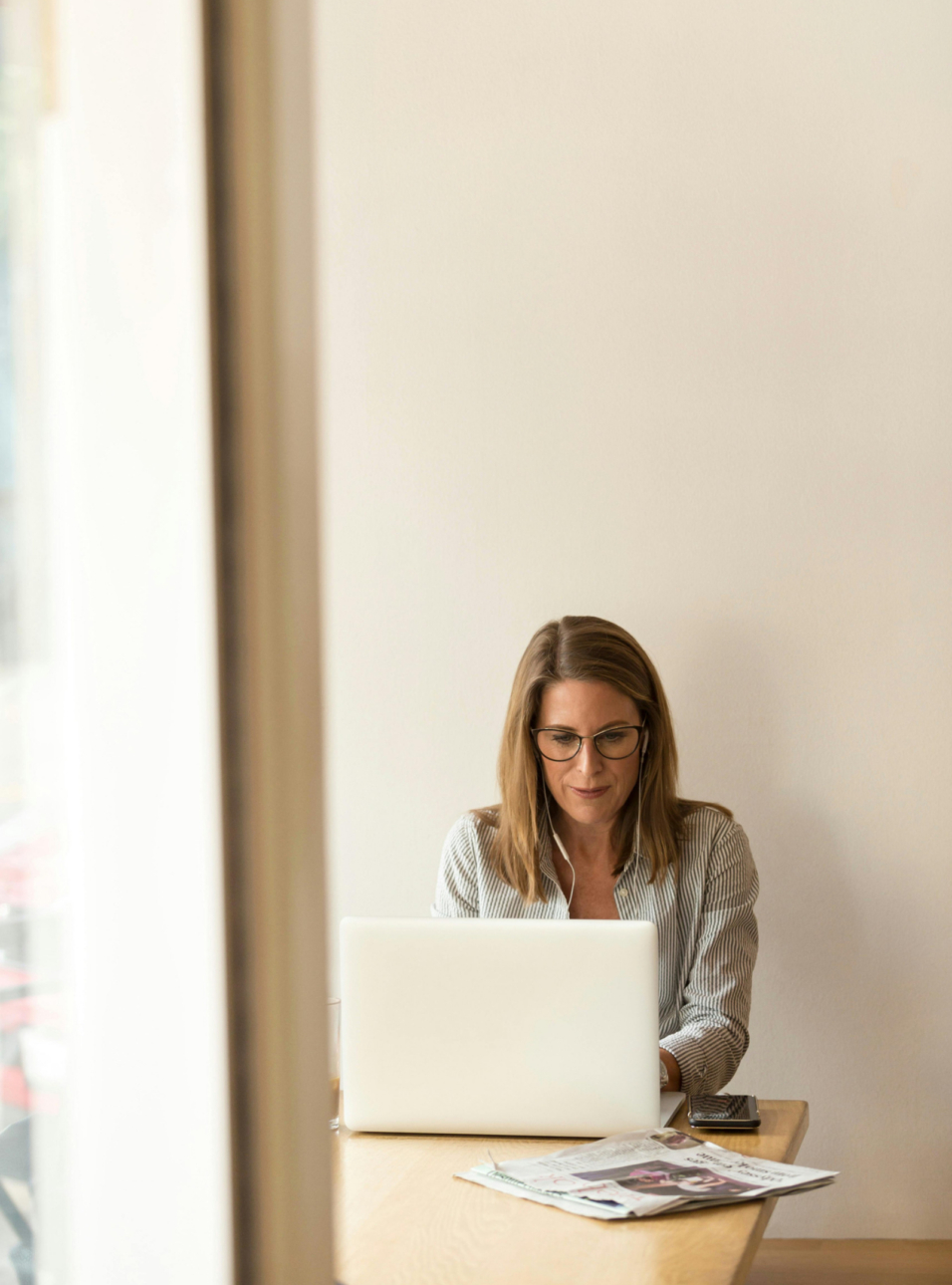 Female psychiatrist working on laptop during telehealth consultation