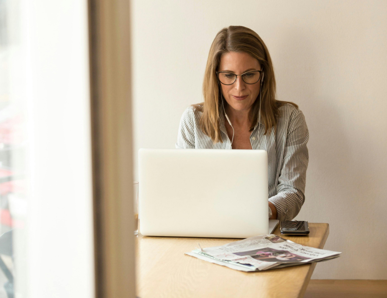 Female psychiatrist working on laptop during telehealth consultation