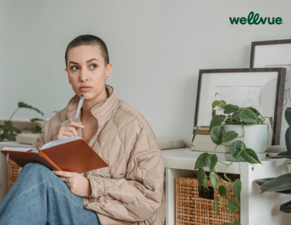 Person reflecting with a pen and notebook, symbolising ADHD coaching in Australia via Wellvue telehealth