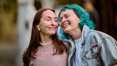 Two adults smiling and connecting outdoors, representing hope and support for people exploring ADHD evaluation through Wellvue
